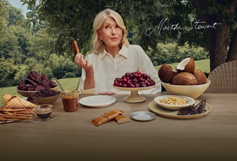 Martha Stewart at an outdoor table with Stars + Honey bars, cherries, coconut, chocolate and coffee, signed Martha Stewart